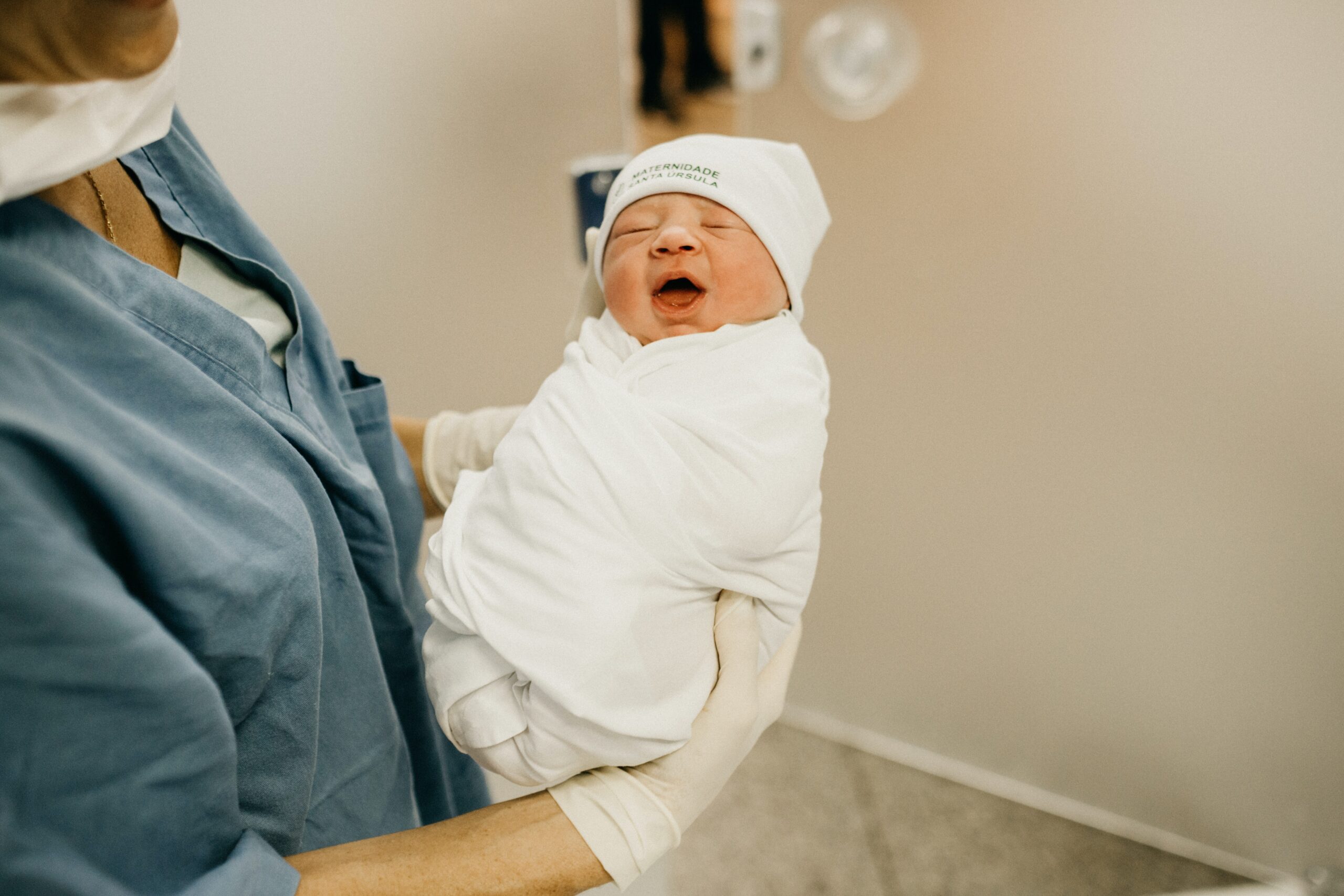 newborn-baby-held-nurse